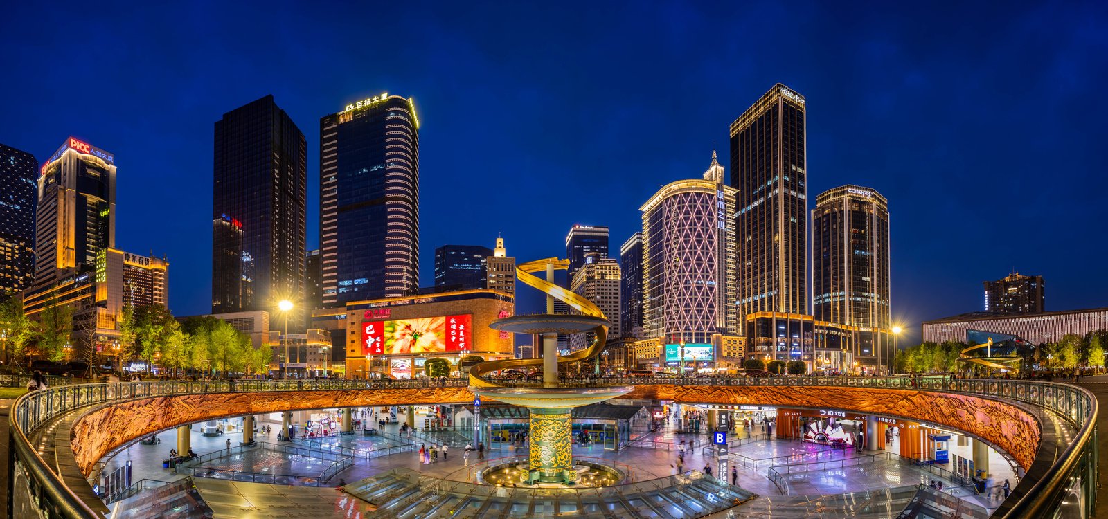 Tianfu Square in Chengdu at blue hour, golden spiral monument surrounded by illuminated towers